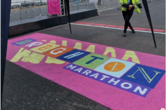 Colourful logo stenciled on the road supporting the Brighton Marathon