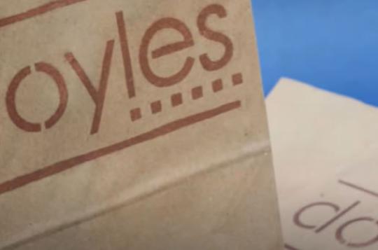 Paper bag with Doyles logo stencilled on