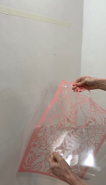 Peeling the clear backing off of a stone mask stencil