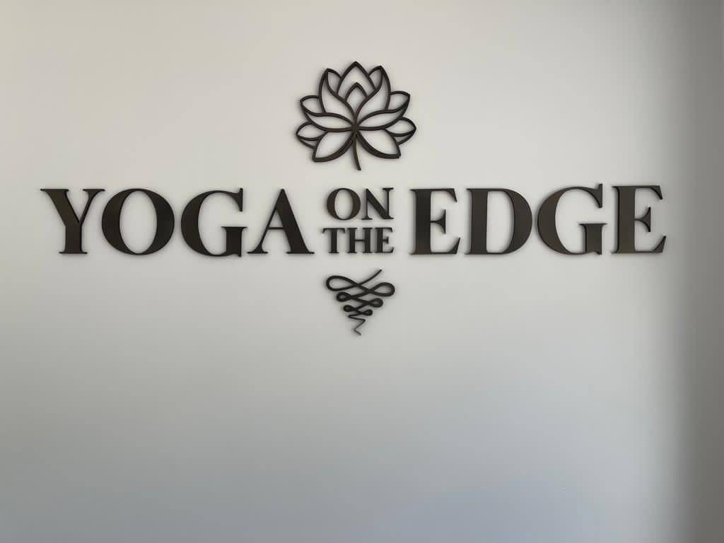 Yoga on the Edge reception sign on white background